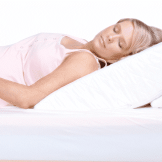 Pregnant woman sleeping on a wedge pillow for body support