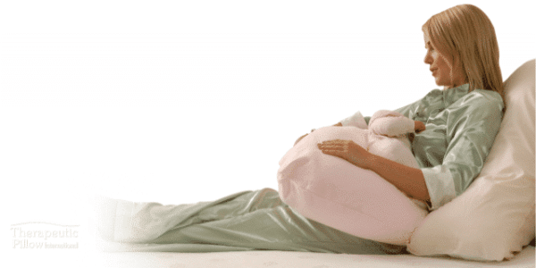 pregnant woman with a baby feeding pillow